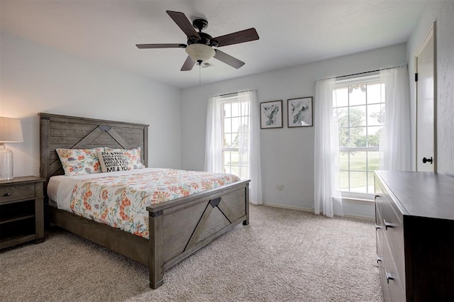 5305 Circle Gln, Edmond, OK 73025 - bedroom featuring multiple windows, light colored carpet, and a ceiling fan