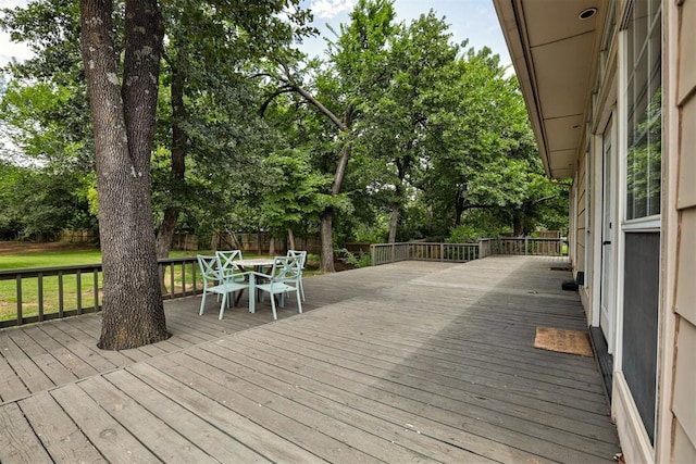 5305 Circle Gln, Edmond, OK 73025 - wooden deck featuring view of scattered trees and outdoor dining area