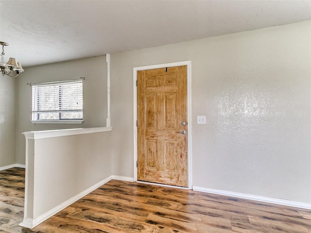 2618 NW Apache Rd, Piedmont, OK 73078 - foyer entrance with wood finished floors and a chandelier