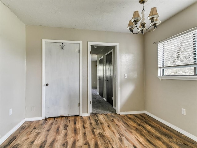 2618 NW Apache Rd, Piedmont, OK 73078 - empty room with a chandelier and wood finished floors
