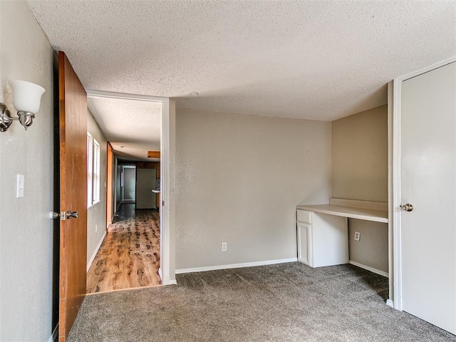 2618 NW Apache Rd, Piedmont, OK 73078 - unfurnished bedroom featuring a textured ceiling, carpet floors, and a desk