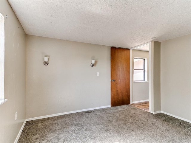 2618 NW Apache Rd, Piedmont, OK 73078 - carpeted spare room with a textured ceiling and baseboards