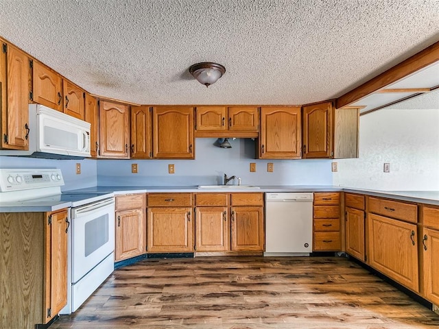 2618 NW Apache Rd, Piedmont, OK 73078 - kitchen featuring white appliances, a textured ceiling, brown cabinets, dark wood-style floors, and light countertops