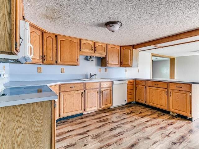 2618 NW Apache Rd, Piedmont, OK 73078 - kitchen featuring white dishwasher, a textured ceiling, light wood finished floors, light countertops, and a peninsula