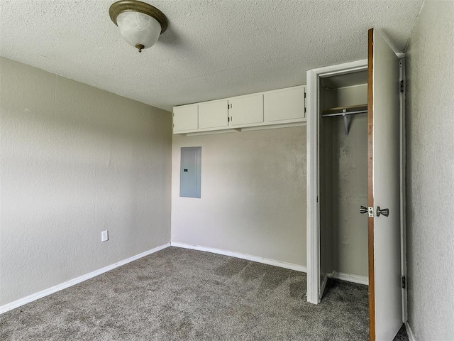 2618 NW Apache Rd, Piedmont, OK 73078 - unfurnished bedroom featuring electric panel, dark colored carpet, a closet, and a textured ceiling