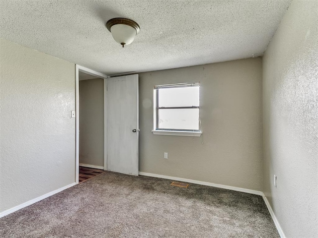 2618 NW Apache Rd, Piedmont, OK 73078 - carpeted empty room featuring a textured wall and a textured ceiling