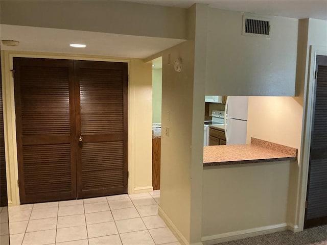 600 NW 4th St Unit 305N, Oklahoma City, OK 73102 - kitchen with white appliances, ventilation hood, and light tile patterned floors
