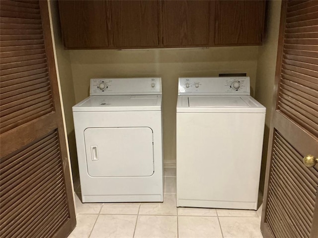 600 NW 4th St Unit 305N, Oklahoma City, OK 73102 - laundry area with independent washer and dryer, cabinet space, and light tile patterned floors