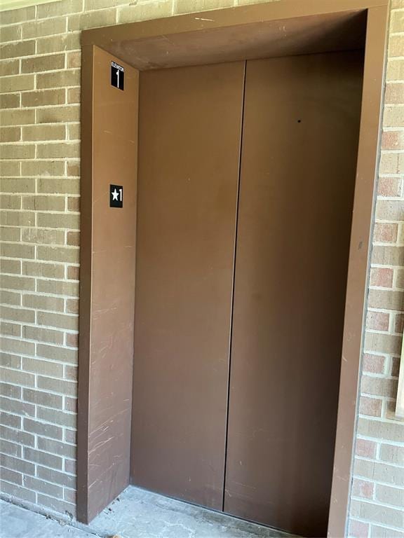 600 NW 4th St Unit 305N, Oklahoma City, OK 73102 - doorway to property featuring elevator and brick siding