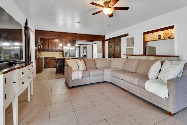 7007 NW 61st St, Bethany, OK 73008 - living area featuring a barn door, a ceiling fan, and light tile patterned floors