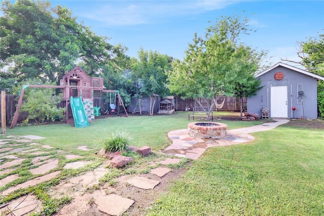 7007 NW 61st St, Bethany, OK 73008 - fenced backyard with a fire pit, a playground, and a shed