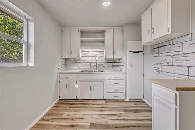 1113 S Locust Dr, Midwest City, OK 73110 - kitchen featuring tasteful backsplash, light wood-type flooring, white cabinets, and open shelves