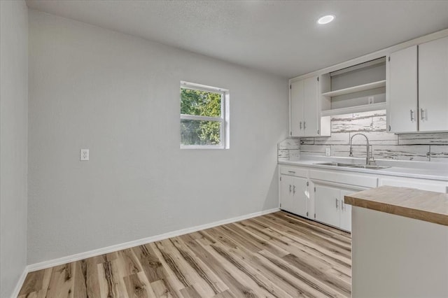 1113 S Locust Dr, Midwest City, OK 73110 - kitchen featuring open shelves, backsplash, light wood finished floors, white cabinetry, and recessed lighting
