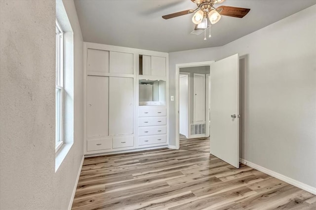 1113 S Locust Dr, Midwest City, OK 73110 - unfurnished bedroom featuring light wood-style floors, ceiling fan, and a closet