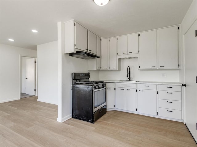 2340 SW 46th St, Oklahoma City, OK 73119 - kitchen featuring gas range oven, under cabinet range hood, light wood-type flooring, recessed lighting, and light countertops