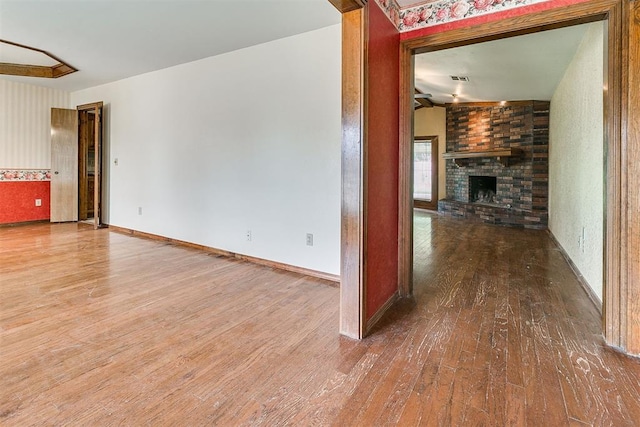 10201 Mantle Ct, Oklahoma City, OK 73162 - unfurnished living room featuring wood finished floors and a fireplace