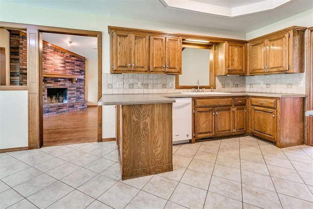 10201 Mantle Ct, Oklahoma City, OK 73162 - kitchen with white dishwasher, light tile patterned floors, and brown cabinetry