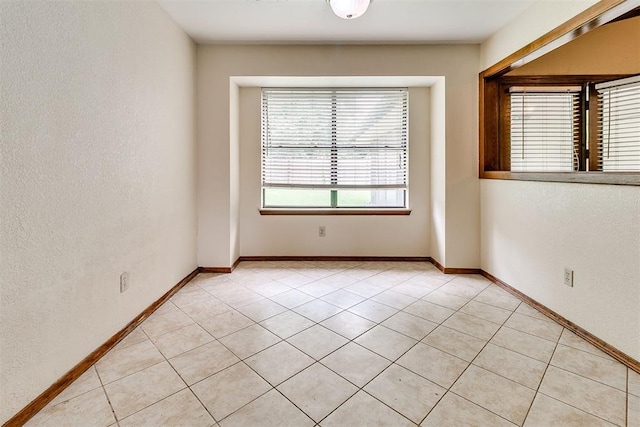 10201 Mantle Ct, Oklahoma City, OK 73162 - empty room with light tile patterned floors and a textured wall