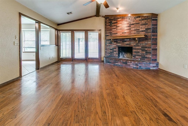 10201 Mantle Ct, Oklahoma City, OK 73162 - unfurnished living room featuring healthy amount of natural light, a ceiling fan, wood finished floors, and a textured wall