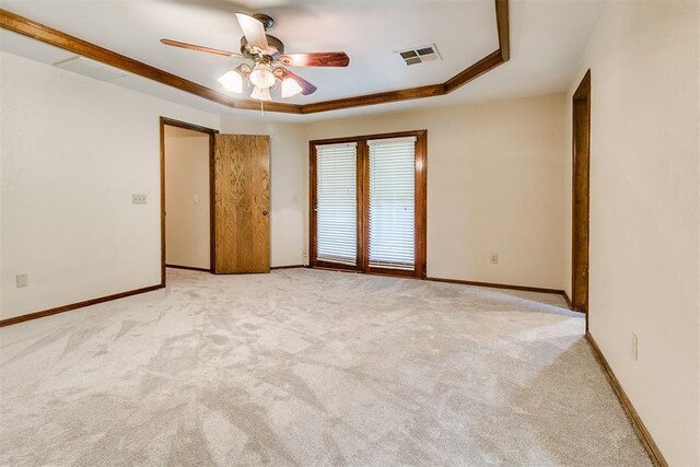 10201 Mantle Ct, Oklahoma City, OK 73162 - unfurnished room featuring a raised ceiling, ceiling fan, and light carpet