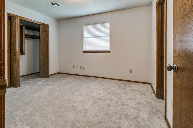 10201 Mantle Ct, Oklahoma City, OK 73162 - unfurnished bedroom featuring carpet, a textured ceiling, and a closet