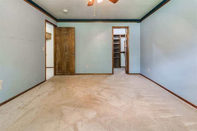 10201 Mantle Ct, Oklahoma City, OK 73162 - unfurnished bedroom featuring crown molding, carpet flooring, a walk in closet, and ceiling fan