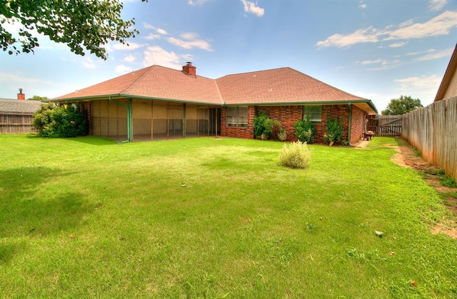 10201 Mantle Ct, Oklahoma City, OK 73162 - back of house featuring a fenced backyard, a chimney, and brick siding