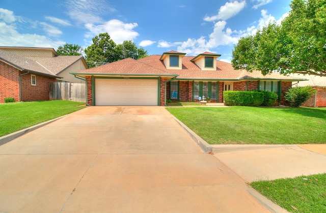 10201 Mantle Ct, Oklahoma City, OK 73162 - view of front of house with an attached garage, brick siding, and driveway