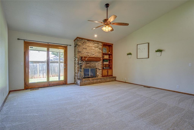 2109 Shamrock Dr, Edmond, OK 73003 - unfurnished living room with lofted ceiling, ceiling fan, carpet, built in shelves, and a fireplace