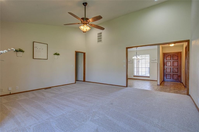 2109 Shamrock Dr, Edmond, OK 73003 - spare room with light carpet, ceiling fan, and high vaulted ceiling