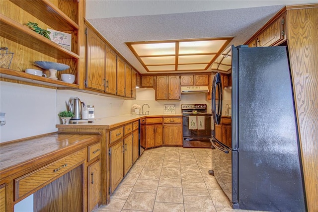 2109 Shamrock Dr, Edmond, OK 73003 - kitchen featuring freestanding refrigerator, range, brown cabinetry, under cabinet range hood, and light countertops