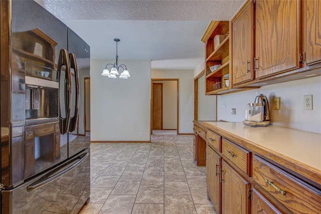 2109 Shamrock Dr, Edmond, OK 73003 - kitchen with refrigerator with ice dispenser, open shelves, brown cabinetry, and a textured ceiling
