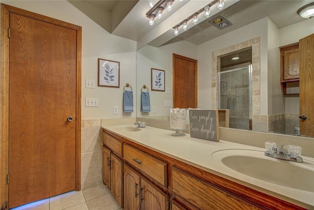 2109 Shamrock Dr, Edmond, OK 73003 - full bathroom with tile patterned floors, double vanity, and a shower stall