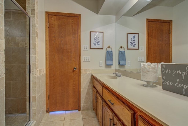 2109 Shamrock Dr, Edmond, OK 73003 - full bath featuring vanity, a stall shower, tile patterned flooring, tile walls, and wainscoting