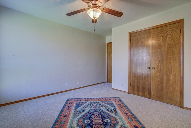 2109 Shamrock Dr, Edmond, OK 73003 - unfurnished bedroom featuring carpet flooring, ceiling fan, and a closet
