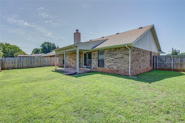 2109 Shamrock Dr, Edmond, OK 73003 - rear view of property featuring a chimney, a patio, a fenced backyard, and brick siding