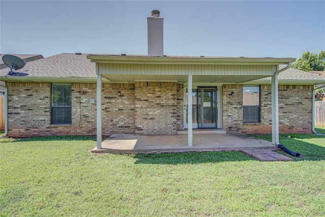 2109 Shamrock Dr, Edmond, OK 73003 - rear view of house featuring a patio area, brick siding, a chimney, and a shingled roof