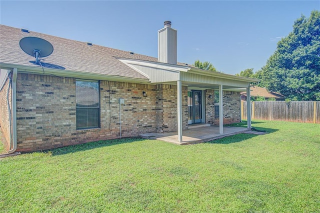 2109 Shamrock Dr, Edmond, OK 73003 - rear view of property with a chimney, a patio area, a shingled roof, and brick siding