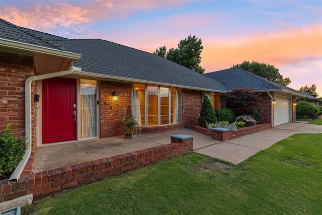 3000 Middlesex Dr, Oklahoma City, OK 73120 - view of front of house with brick siding, a front lawn, an attached garage, driveway, and roof with shingles