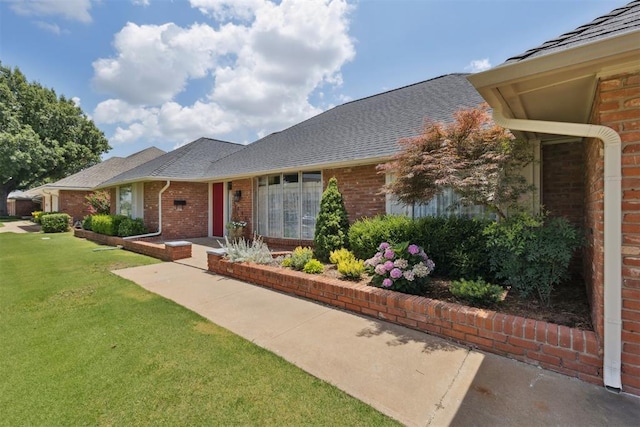 3000 Middlesex Dr, Oklahoma City, OK 73120 - ranch-style home featuring brick siding, a front lawn, and roof with shingles