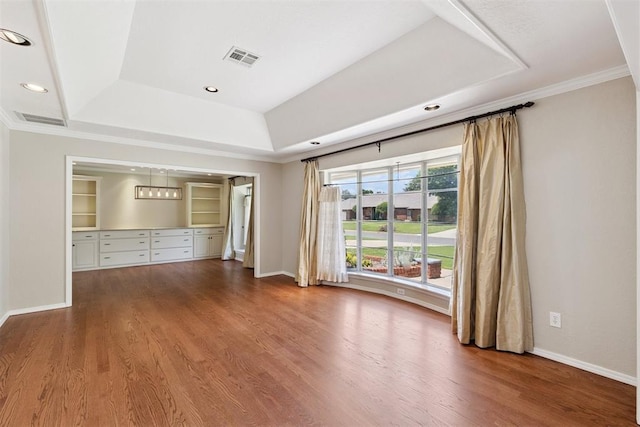 3000 Middlesex Dr, Oklahoma City, OK 73120 - unfurnished living room with crown molding, a raised ceiling, wood finished floors, and recessed lighting