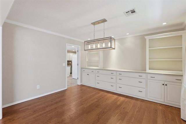 3000 Middlesex Dr, Oklahoma City, OK 73120 - unfurnished dining area with wood finished floors, crown molding, and recessed lighting