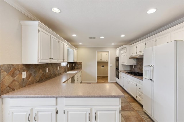 3000 Middlesex Dr, Oklahoma City, OK 73120 - kitchen with black appliances, backsplash, under cabinet range hood, ornamental molding, and a peninsula