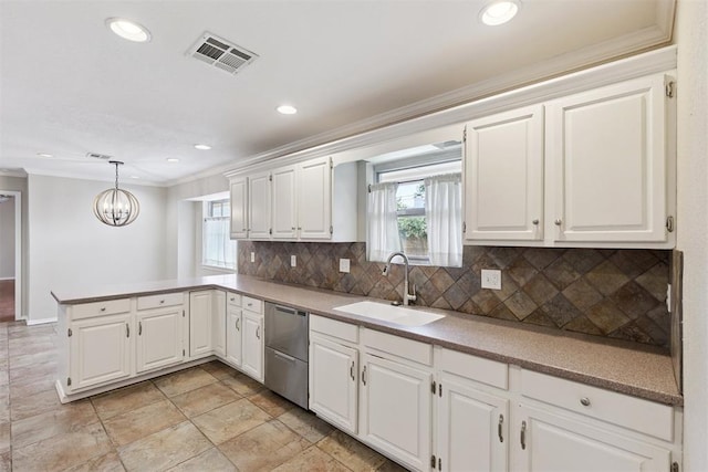 3000 Middlesex Dr, Oklahoma City, OK 73120 - kitchen featuring stainless steel dishwasher, ornamental molding, a peninsula, backsplash, and a chandelier