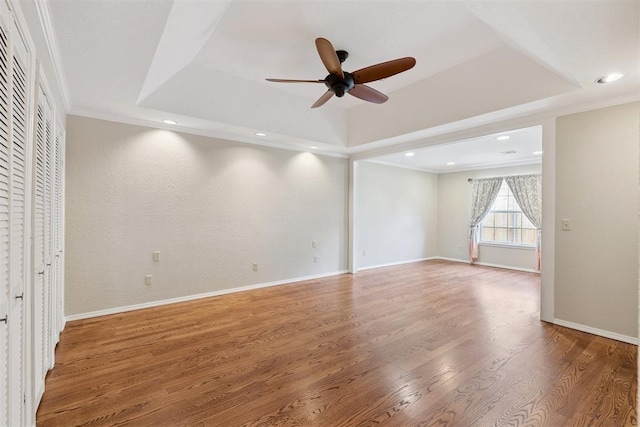 3000 Middlesex Dr, Oklahoma City, OK 73120 - empty room featuring a raised ceiling, ceiling fan, ornamental molding, wood finished floors, and recessed lighting