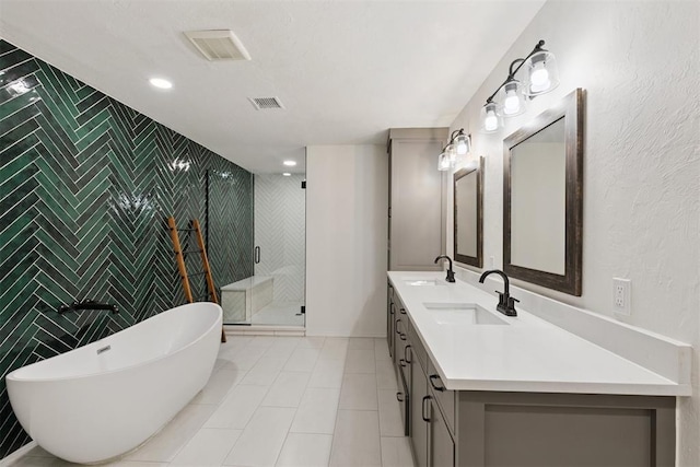 3000 Middlesex Dr, Oklahoma City, OK 73120 - bathroom with double vanity, a soaking tub, a shower stall, tile walls, and tile patterned flooring