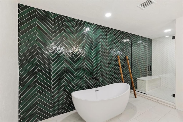 3000 Middlesex Dr, Oklahoma City, OK 73120 - bathroom featuring tile walls, a freestanding bath, a shower stall, tile patterned floors, and recessed lighting