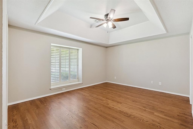 3000 Middlesex Dr, Oklahoma City, OK 73120 - unfurnished room featuring a raised ceiling, a ceiling fan, and wood finished floors