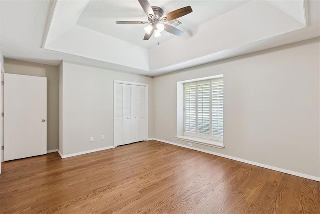 3000 Middlesex Dr, Oklahoma City, OK 73120 - unfurnished bedroom featuring a raised ceiling, wood finished floors, a closet, and a ceiling fan