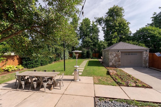 1005 NW 40th St, Oklahoma City, OK 73118 - view of patio / terrace featuring an outdoor structure, outdoor dining space, a garage, and driveway